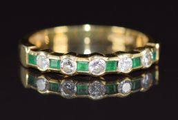 An 18ct gold half eternity ring set with baguette cut emeralds and round cut diamonds, 3.2g, size M