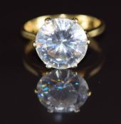 An 18ct gold ring set with a round cut white sapphire of approximately 4ct, 3.7g, size H