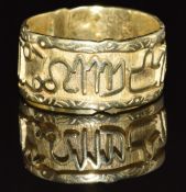 A yellow metal ring (tests as 18k) with symbol decoration, 5.9g, size R