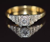 An 18ct gold ring set with a diamond in a tiered platinum setting, 2.9g, size M