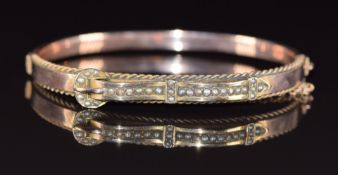Edwardian 9ct rose gold bangle set with seed pearls in a buckle design, 8.1g, 5.5 x 4.5cm