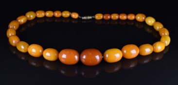 Baltic amber necklace made up of 19 oval beads, 30.6g, largest bead 2.2 x 1.7cm, smallest bead 0.7 x