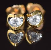 A pair of 18k gold earrings each set with a round cut diamond of approximately 0.15ct, 1.1g