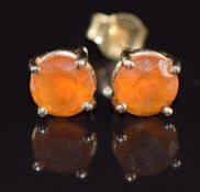 A pair of 14k gold earrings each set with a round cut fire opal of approximately 0.75ct, 1.3g