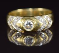 An 18ct gold ring set with a round cut diamond of approximately 0.26ct and further diamonds to the
