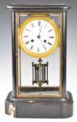 Black marble or slate cased 19thC mantel clock, the white enamel dial having Roman numerals,