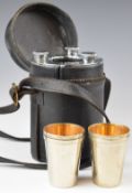 Cased travelling drinks set comprising three hip or spirit flasks and four cups, height 17cm