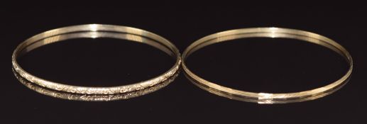 Two 9ct gold bangles, one with scrolling decoration the other with textured decoration, 10.9g, 6.2 &