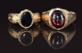 A 9ct gold ring set with a garnet cabochon (size N) and a 9ct gold ring set with onyx, size F, 5.1g