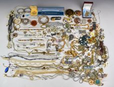 A collection of costume jewellery including Sarah Coventry brooch, freshwater pearls, silver