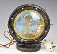 An aquarium lamp in ship's wheel surround, height 27cm