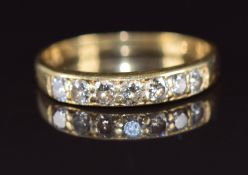An 18ct gold ring set with seven round cut diamonds, the total diamond weight approximately 0.5ct,