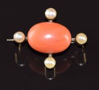 A c1910 9ct gold brooch set with a coral cabochon and split pearls, 4.5g, 2.4 x 2cm