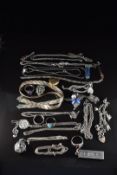 A collection of silver jewellery including three rings, charm bracelet, tri-coloured necklace,