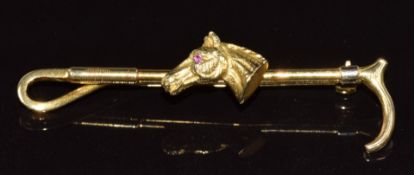 A 9ct gold bar brooch in the form of a horse's head set with a ruby eye and crop, 6.7g, 5.7cm