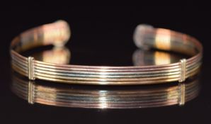 A 9ct gold tri-coloured bangle, 6.2g