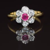 An 18ct gold ring set with a ruby of approximately 0.3ct and diamonds totalling approximately 0.58ct