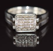 An 18k white gold ring set with black diamonds and diamonds in a reversible rectangular setting, 5.