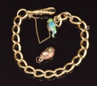 An 18ct gold bracelet made up of oval twisted links (24.6g) with a silver charm in the form of a