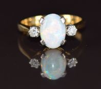 An 18ct gold ring set with an oval cut opal cabochon and diamonds, 3.1g, size J