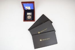 Four silver 1oz Britannia coins, three mounted in Jubilee Mint commemorative coin covers and one
