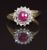 A 9ct gold ring set with a ruby of approximately 0.8ct surrounded by diamonds, 3g, size R