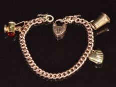 A 9ct rose gold charm bracelet with two 9ct gold charms and a 9ct gold back and front locket, 20g,