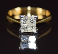 An 18ct gold ring set with four princess cut diamonds totalling approximately 0.75ct, with