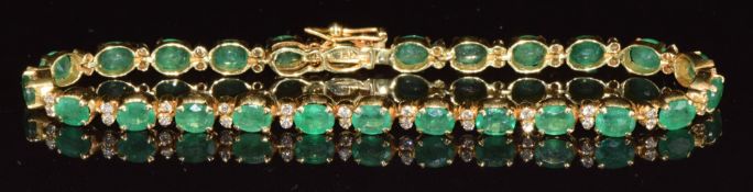 An 18ct gold bracelet set with 25 oval cut emeralds, each approximately 0.3ct and diamonds (total
