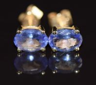 A pair of 14k gold earrings each set with an oval cut tanzanite of approximately 0.65ct, 1.1g