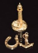 Three 9ct gold charms comprising one in the form of a lighthouse and cottage (3.4g, 2.5cm), one in