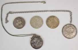 Three Maria Theresia silver coins, one mounted with chain, together with an 1883 Queen Victoria