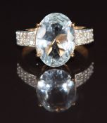 A 9ct gold ring set with an oval cut aquamarine of approximately 4.5ct and diamonds, 3.7g, size N