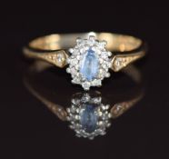 A 9ct gold ring set with an oval cut sapphire and diamonds, 2.2g, size K