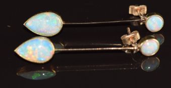 A pair of 9ct gold earrings each set with a round cut opal of cabochon of approximately 0.3ct each