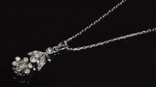 A 14k white gold necklace set with round cut diamonds totalling approximately 0.58ct, in a floral
