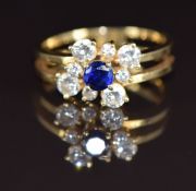 An 18k gold ring set with a round cut sapphire and round brilliant cut diamonds, 3.6g, size L