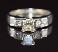 A 14ct gold ring set with a princess cut diamond of approximately 0.6ct and four further princess