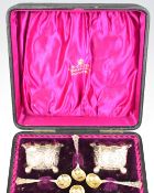 Cased set of four Victorian hallmarked silver open salts with gilt interiors and matching spoons,