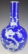 Chinese bottle vase with blue and white prunus decoration and seal mark to base, height 46cm