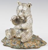White metal figure of a panda eating bamboo, on raised bronze base, with plaque to base marked 925