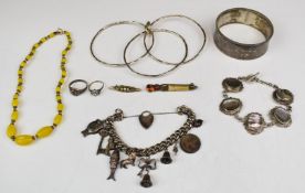 A silver bangle / cuff, another silver bangle made up of three bangles joined together, silver charm