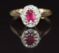 A 9ct gold ring set with an oval cut ruby of approximately 0.4ct surrounded by diamonds, 2.1g,