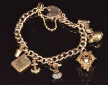 A 9ct gold charm bracelet with seven 9ct gold charms including a dog, lamp, jug, bible, anchor, etc,