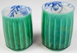 A near pair of Japanese fluted green glazed cups with interior floral decoration and seal mark to