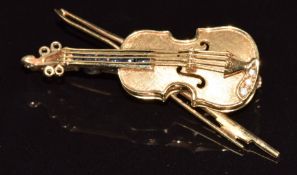 A 9ct gold brooch in the form of a violin set with three diamonds and sapphires, 5.2g, 3.5cm
