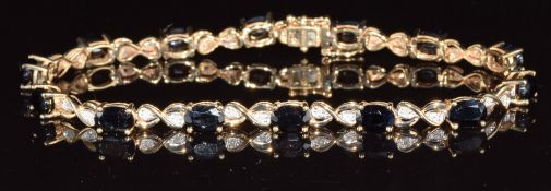 A 9ct gold bracelet set with oval cut sapphires and diamonds, 9.3g, 18cm long