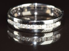 An 18ct white gold half eternity ring set with twelve round cut diamonds, 4g, size M