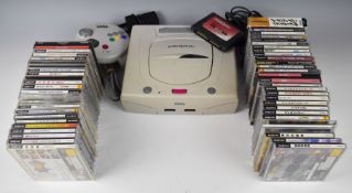 Japanese Sega Saturn retro video game console with UK power adaptor and controller together with