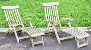 Pair of teak reclining garden steamer chairs with cushions, length 160cm